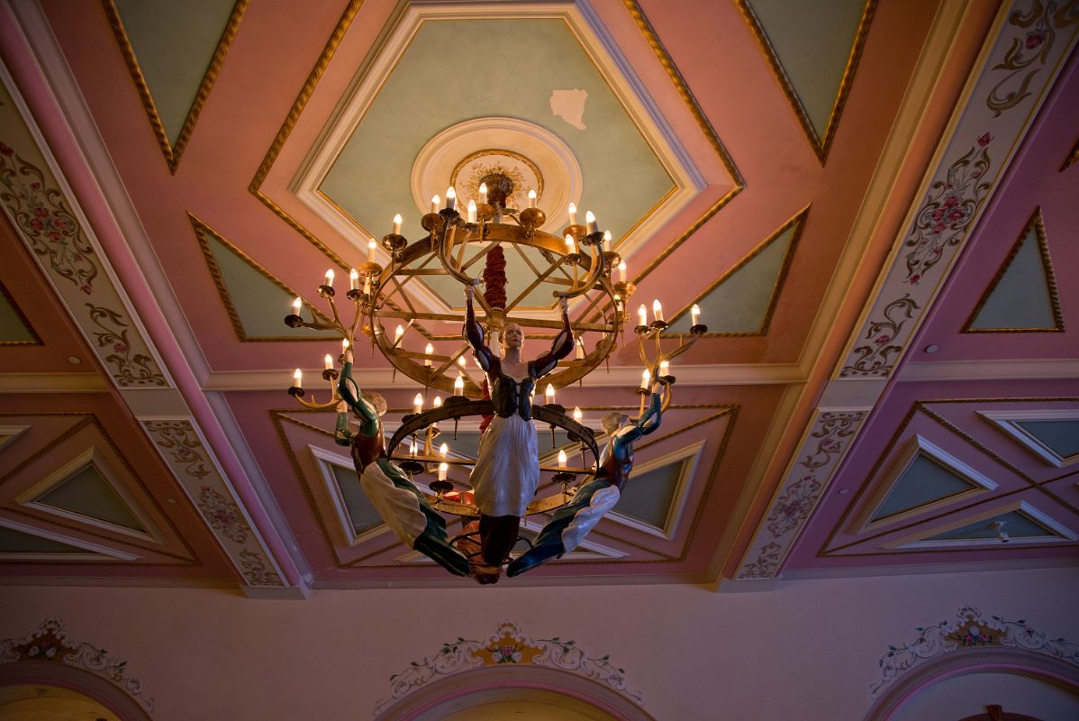 11 Chandelier Held Up By Three Female Statues At Chateau Lake Louise